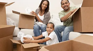 A family packing away items to be stored